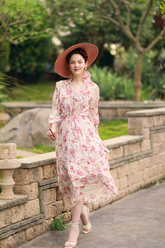 a lady in a pink floral printed dress